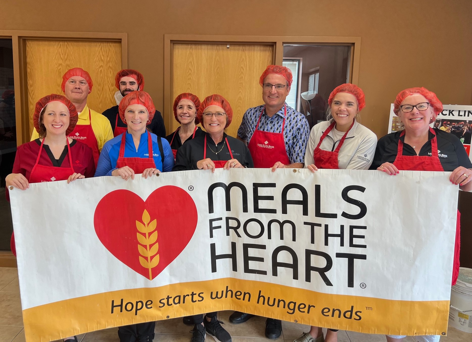 Group picture of Lake ELmo employees that packed meals for Meal from the Heart.